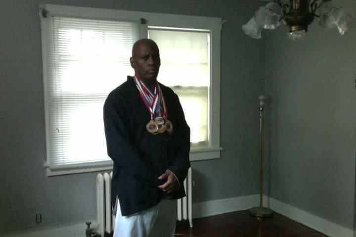 Black Pinoy Joel Crafton pictured wearing martial arts medals as a champion in Taekwondo and Hapkido with over 400 gold medals and international recognition.