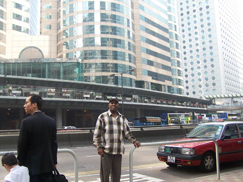 Black Pinoy Joel Crafton pictured in Central Hong Kong, reflecting international connection through music, culture, and travel.