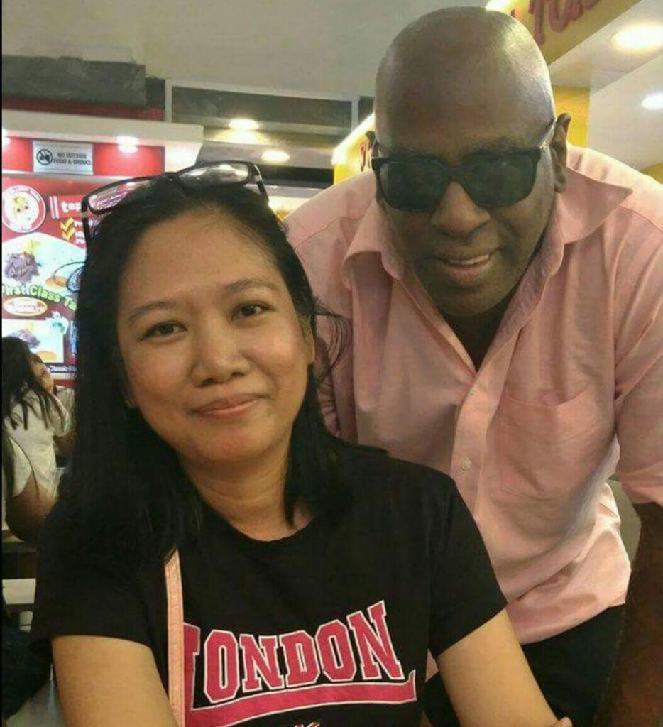 Black Pinoy Joel Crafton standing with supporters during an international appearance.